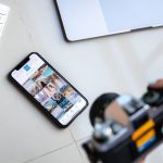 Mulher jovem criando conteúdo sensual e sorrindo para a câmera com smartphone